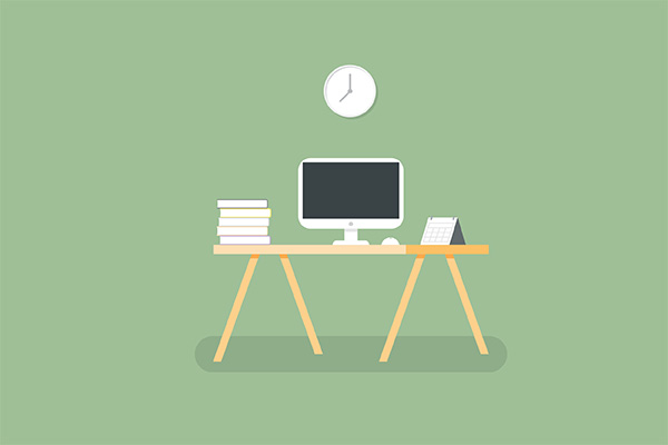 Desk setup with computer monitor, stack of books, keyboard, and notepad on a wooden table against a green background.