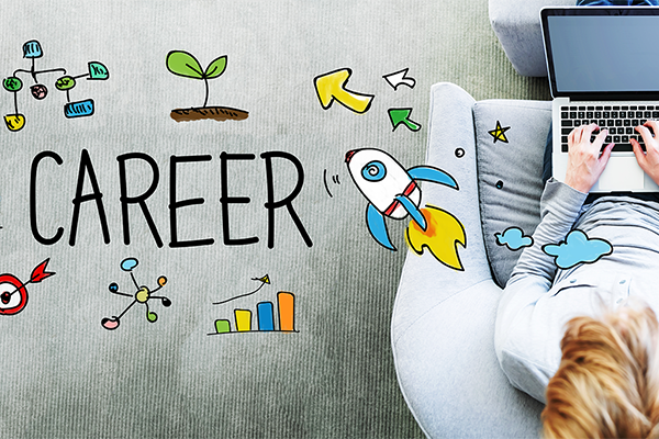 Person on a couch using a laptop with a career-themed wall mural including the word CAREER, rocket, charts, and arrows nearby.