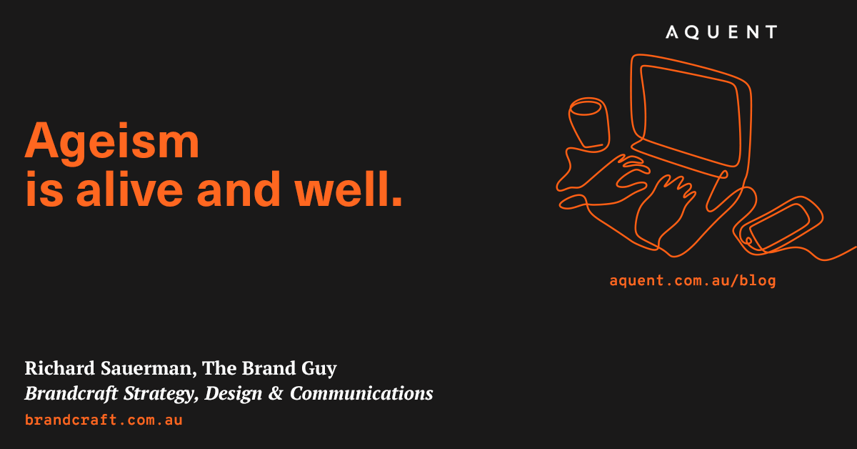 Dark hero banner with bold orange headline 'Ageism is alive and well.' on the left and an orange line-drawing of a computer and hands on the right; AQUENT logo at top-right.
