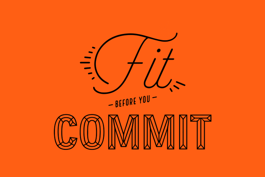 Orange poster with decorative black typography reading 'Fit before you commit,' emphasizing the message over imagery.
