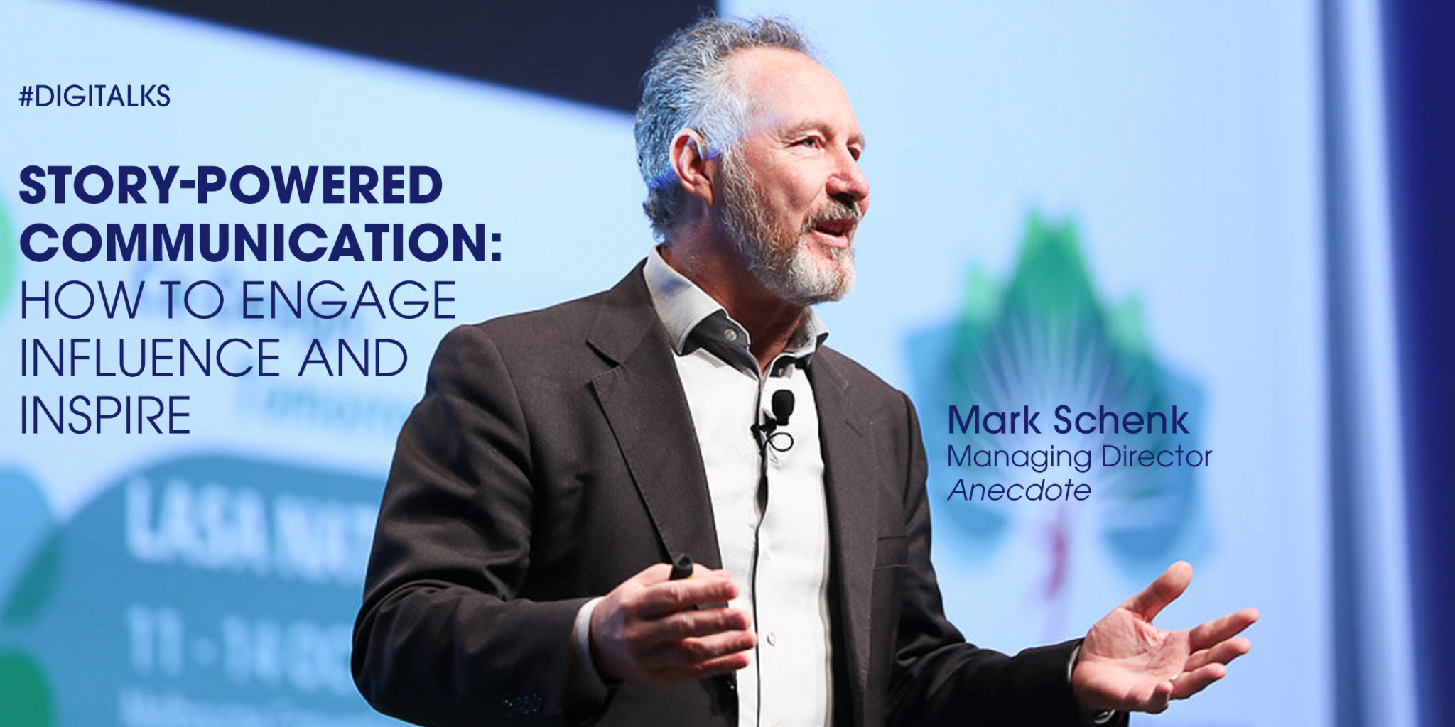 Speaker Mark Schenk on stage delivering a talk about story-powered communication; backdrop shows #DIGITALKS and title text.