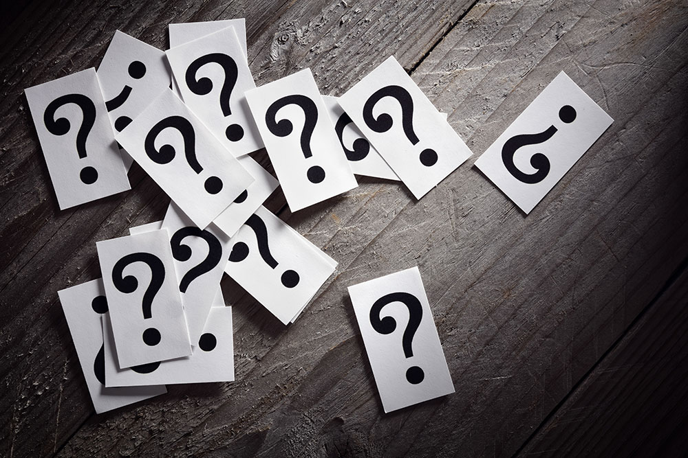 Question mark cards on a wooden floor