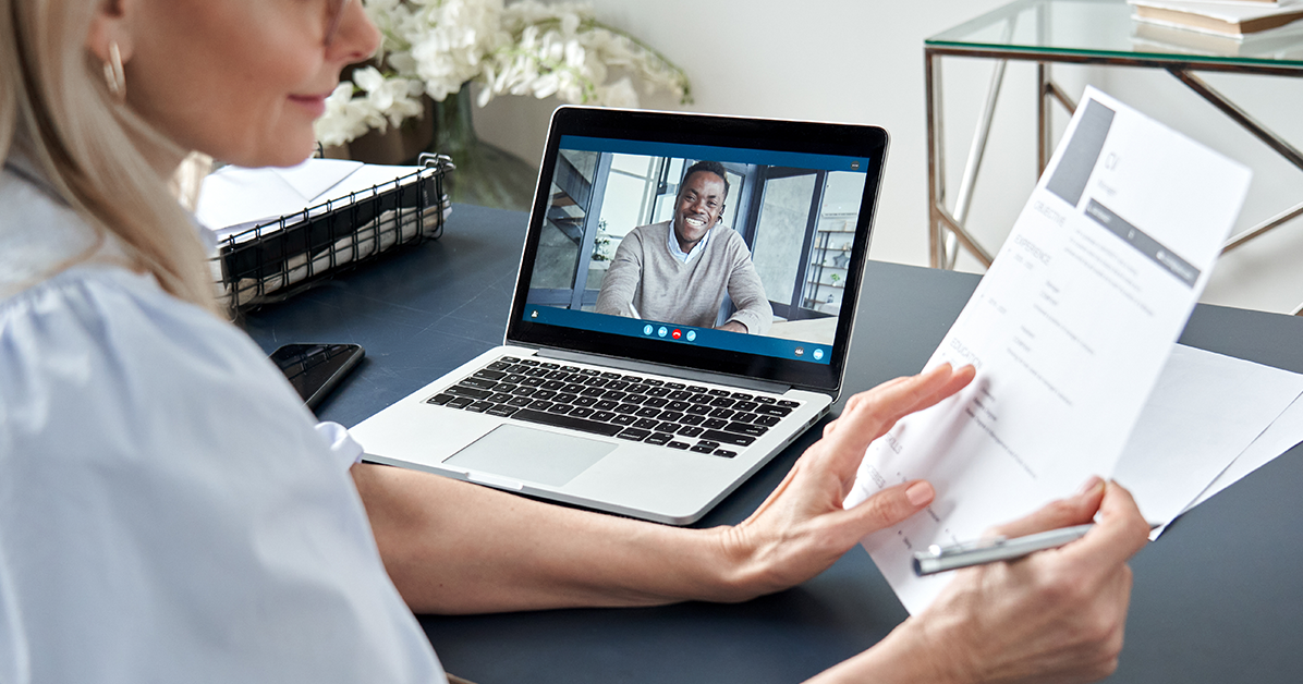 Man on a video call job interview with a woman